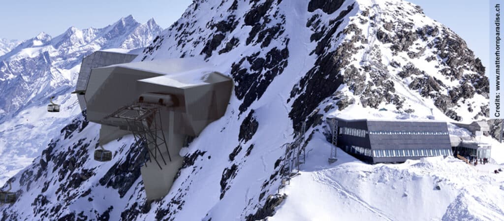 The Alpin X project, implemented by Zermatt Bergbahnen, creates a tourist connection between Zermatt (Switzerland) and Cervinia (Italy) via the summit of the Klein Matterhorn. For this purpose, two new cableway mountain stations have been built at the summit at an altitude of 3820 m on the 50° to 70° inclined rock faces.